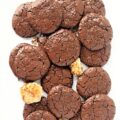 Flat chocolate cookies with shiny, crackled tops.