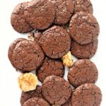 Flat chocolate cookies with shiny, crackled tops.
