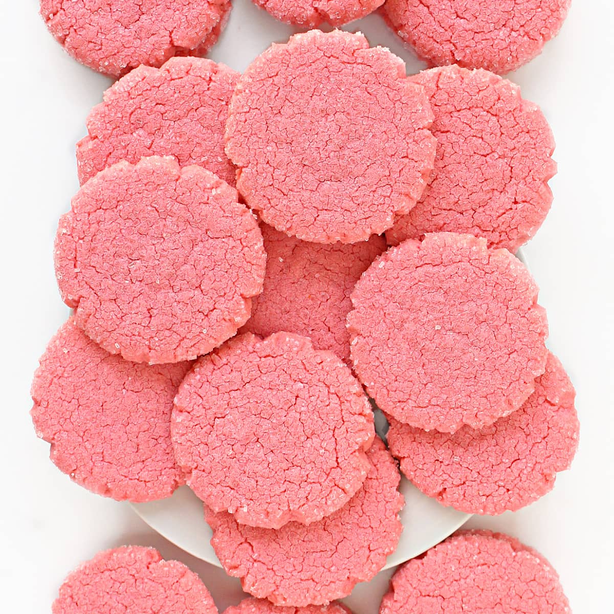 Closeup showing the crackled, flat tops of the large pink cookies.
