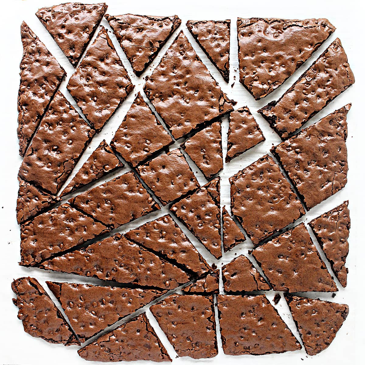 Brownie brittle randomly cut into wedges of different sizes.