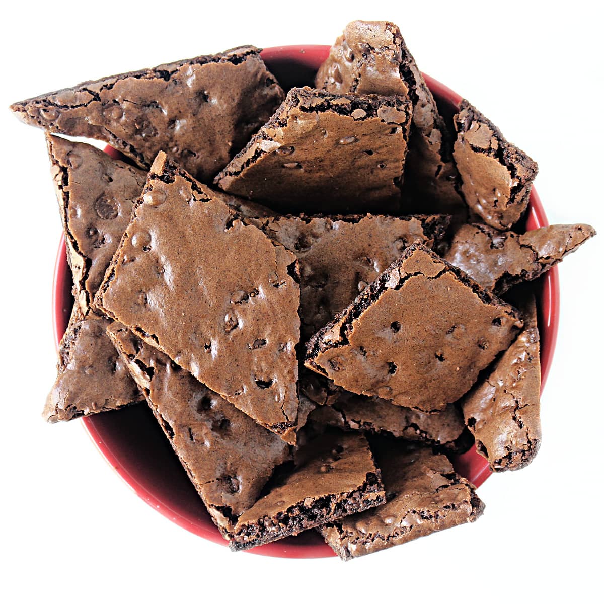 Overhead image of thin brownie cookie wedges in a bowl.