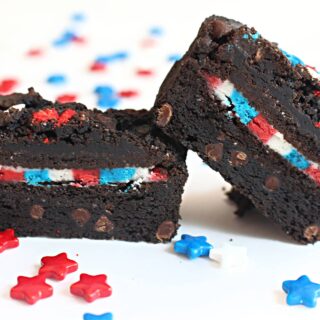 Brownie with a sandwich cookie inside that is filled with red, white, blue icing.