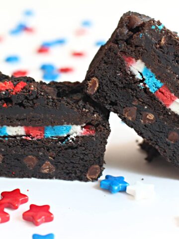 Brownie with a sandwich cookie inside that is filled with red, white, blue icing.