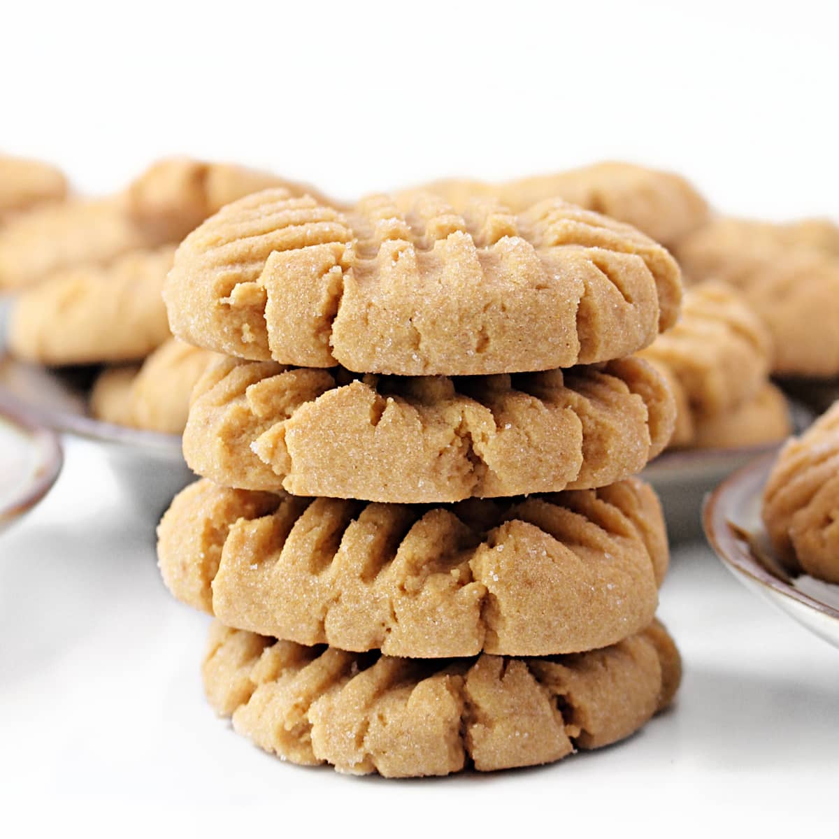 Stack of thick peanut butter cookies with sugar coating.