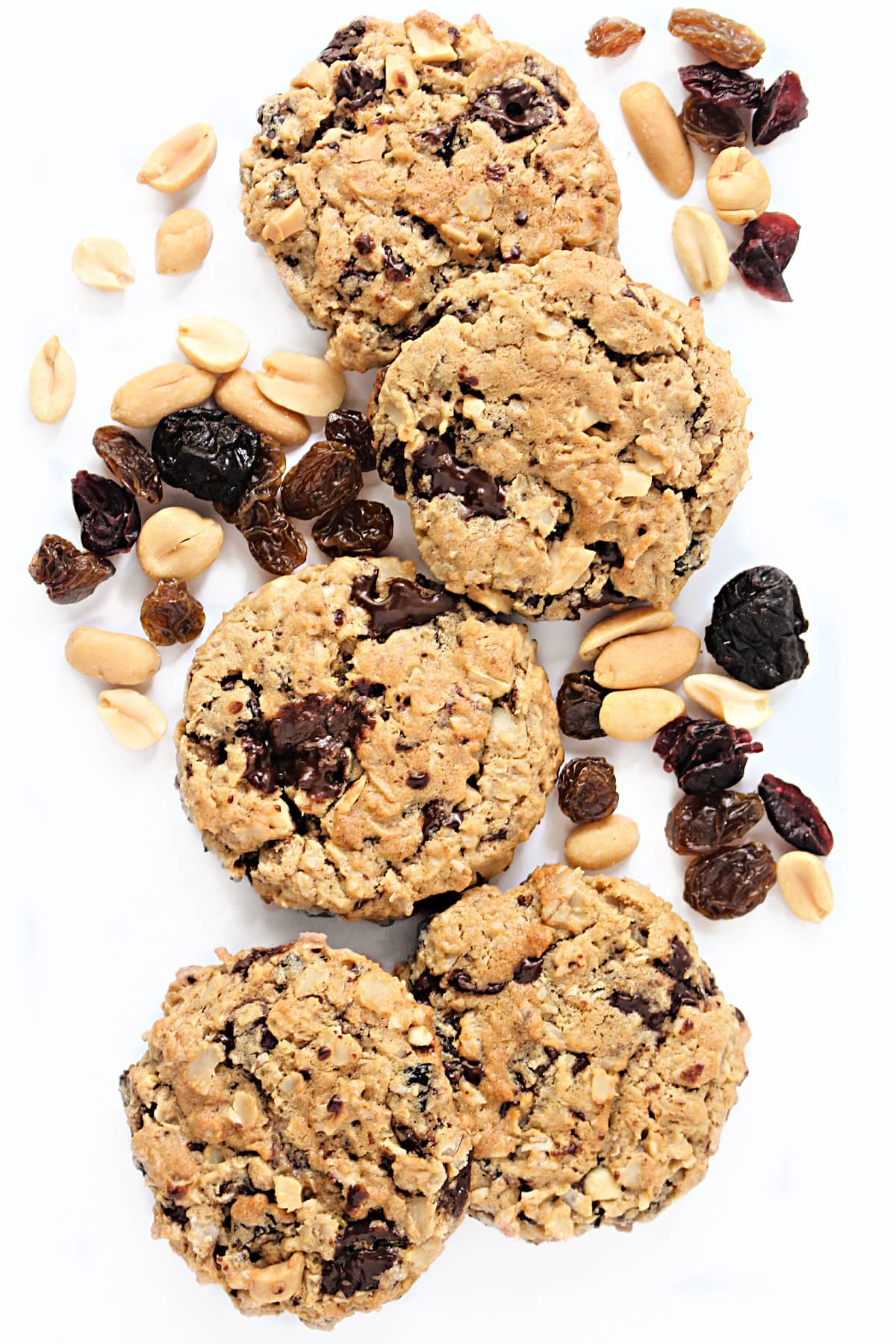 Craggy oatmeal cookies with bits of peanuts and melted chocolate.