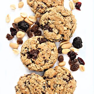 Thick oatmeal runners cookies with bits of chocolate, dried fruit, and peanuts.