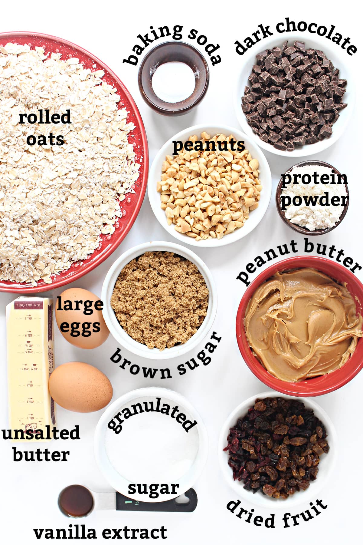 Ingredients: oats, butter, peanut butter, eggs, brown sugar, white sugar, dried fruit, peanuts, vanilla, protein powder, chocolate, baking soda.