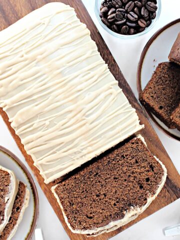 Dark brown coffee loaf cake topped with coffee icing.