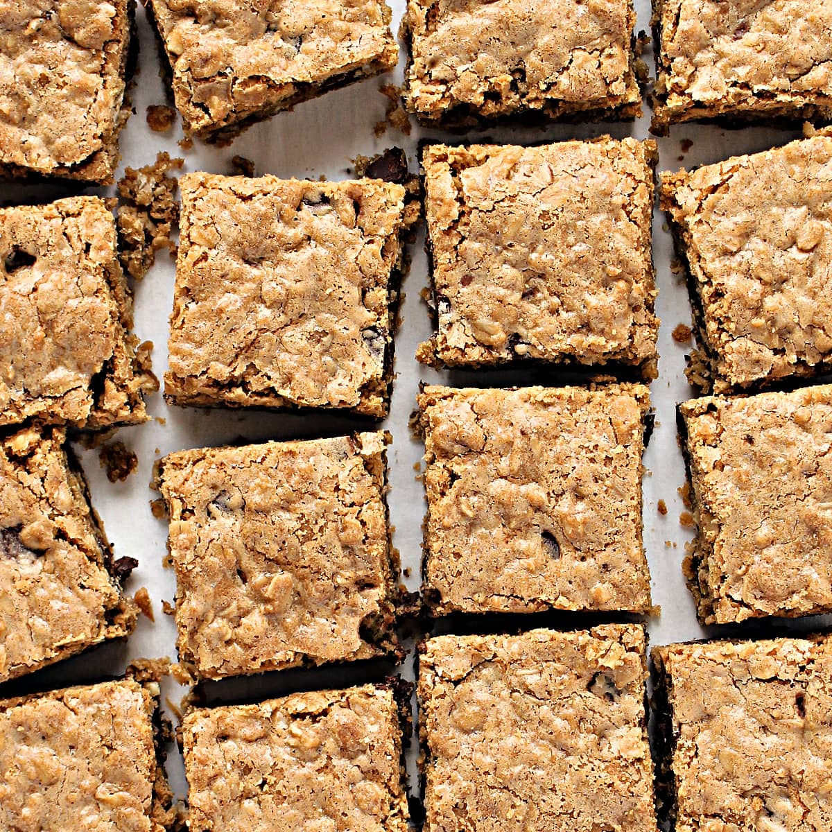 Closeup of textured, slightly crackled tops of Oat Bars cut in squares.