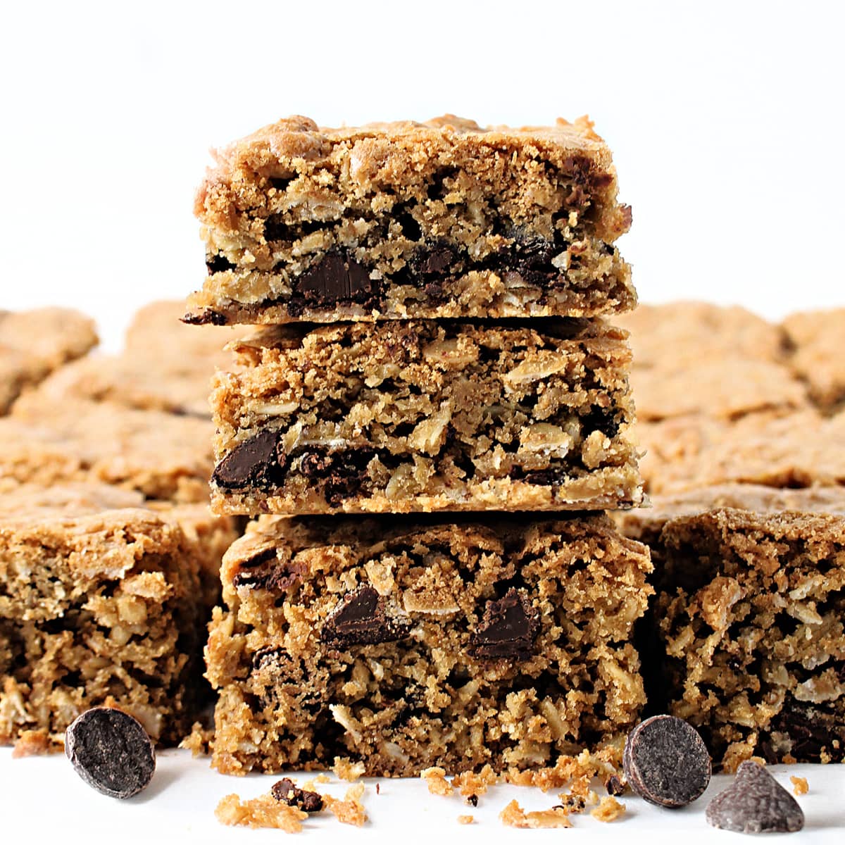 Stack of oatmeal bars showing interior with oats and chocolate chips.