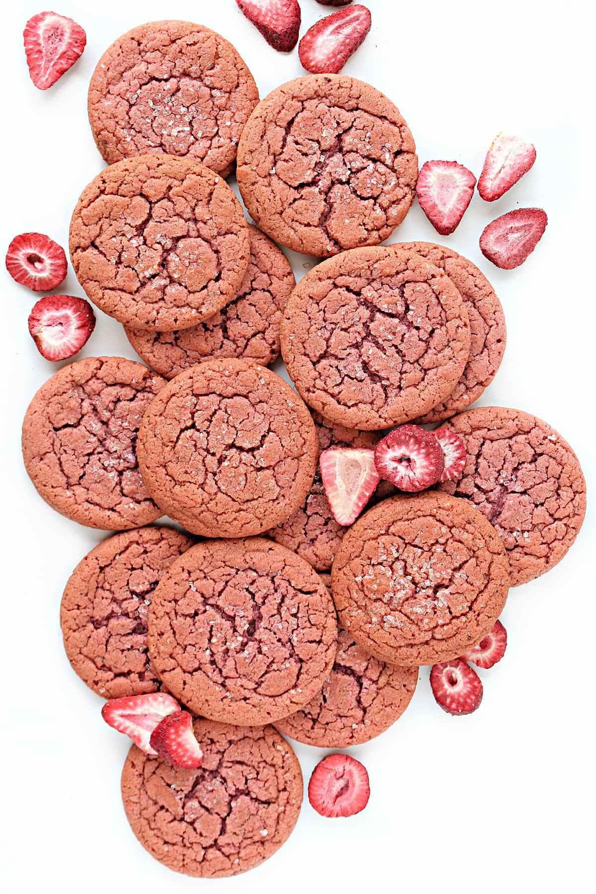 Flat, pink cookies with cracked tops sprinkled with decorating sugar crystals.