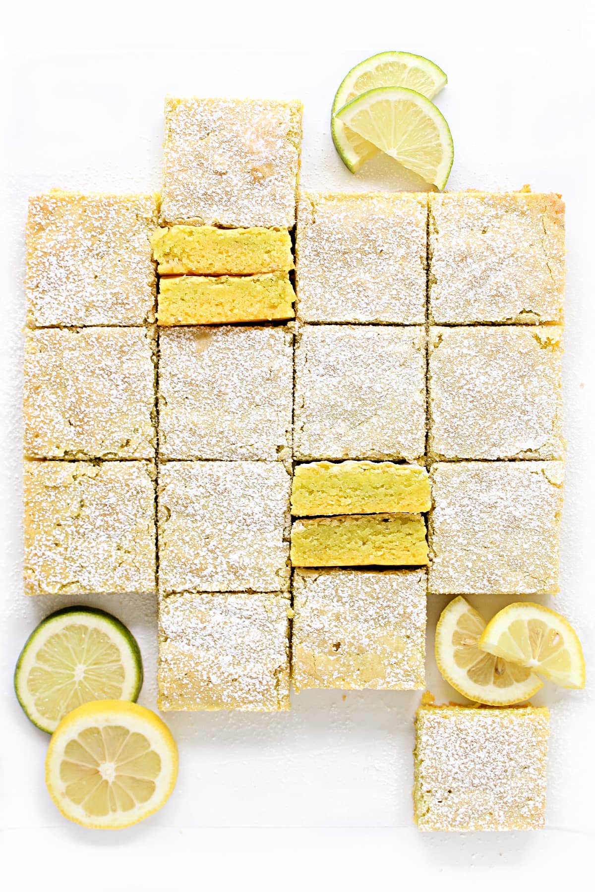 Lemon Lime Bars cut in squares and topped with powdered sugar.