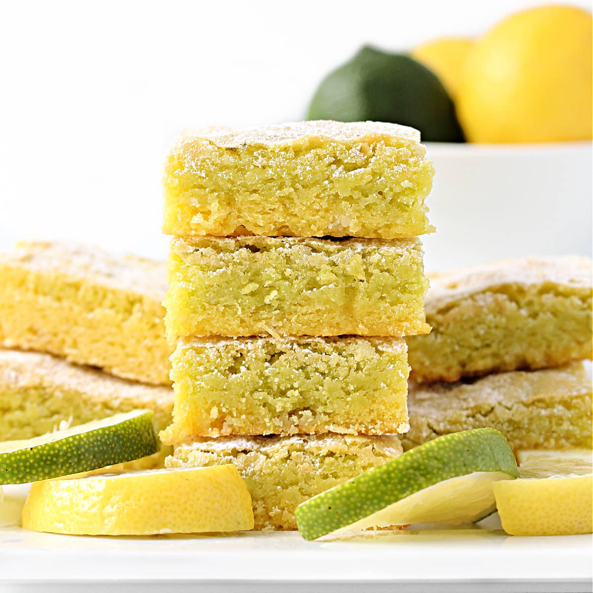 Stack of Lemon Lime Bars showing the lemon layer topped with the lime layer.