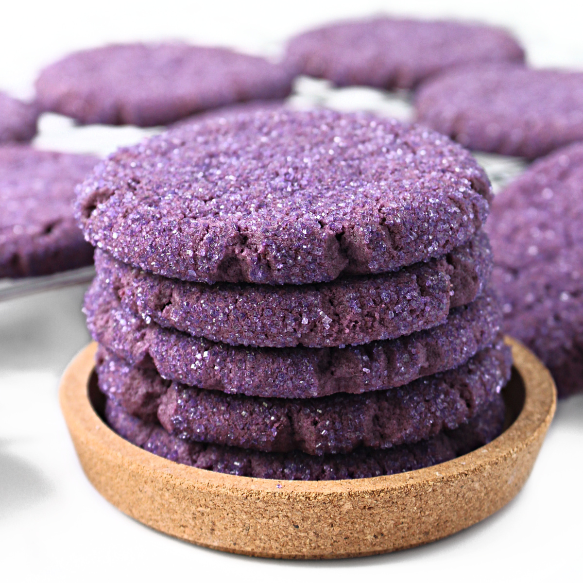 Stack of thick, purple cookies coated in sparkling sugar.