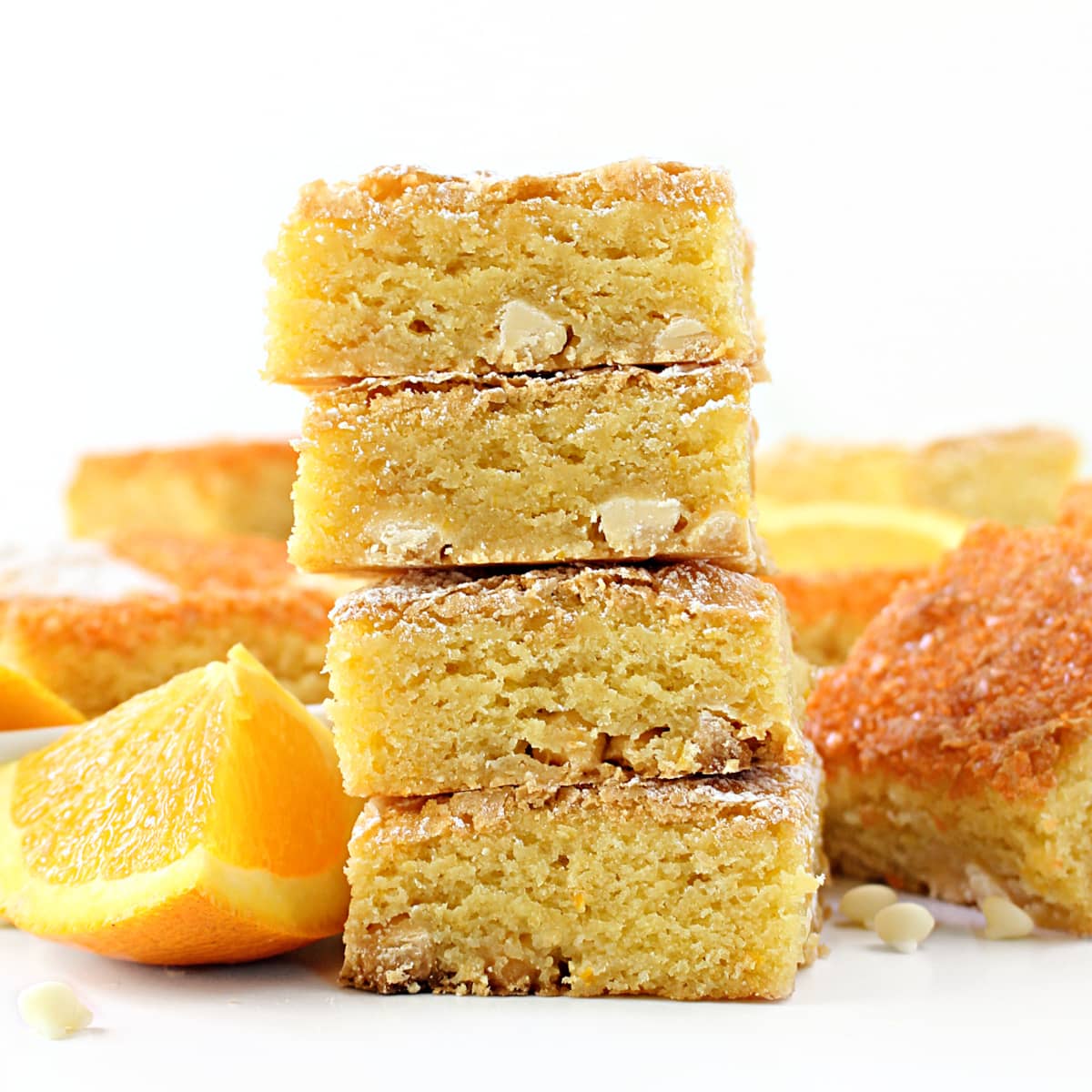 Stack of thick, dense orange bars showing cut edge and moist crumb.