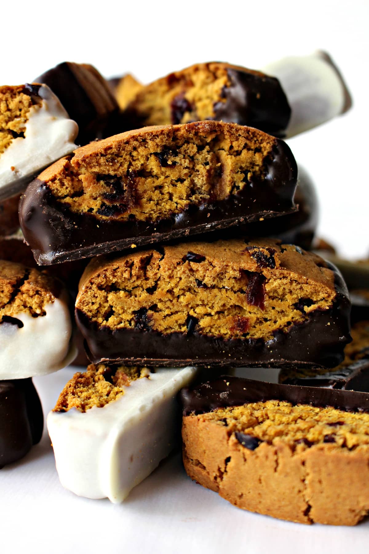 Pumpkin Cranberry Biscotti, speckled with dried cranberries, and bottoms dipped either in dark or white chocolate.