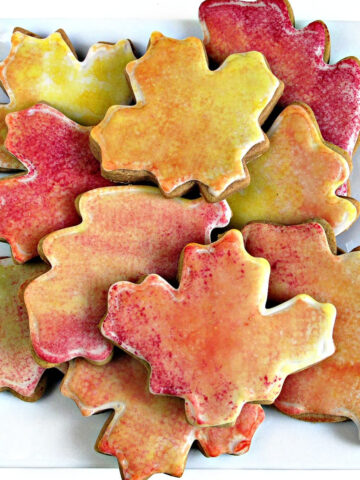 Gingerbread cookies cut out in leaf shapes iced with fall colors.