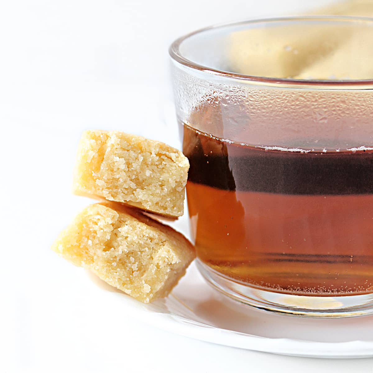 Tea cup with shortbread cookies on the side, showing interior buttery crumb.