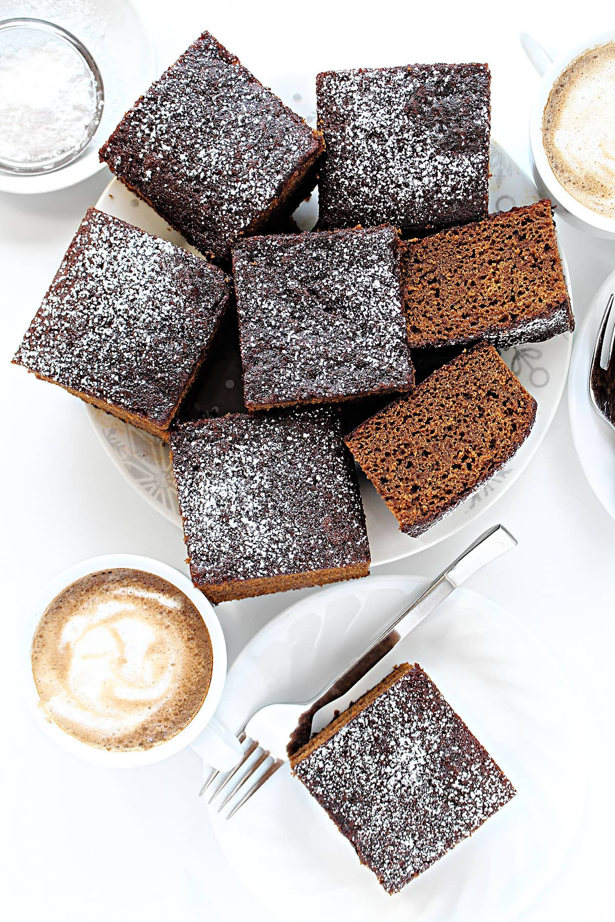 Squares of fluffy Gingerbread Cake topped with powdered sugar.