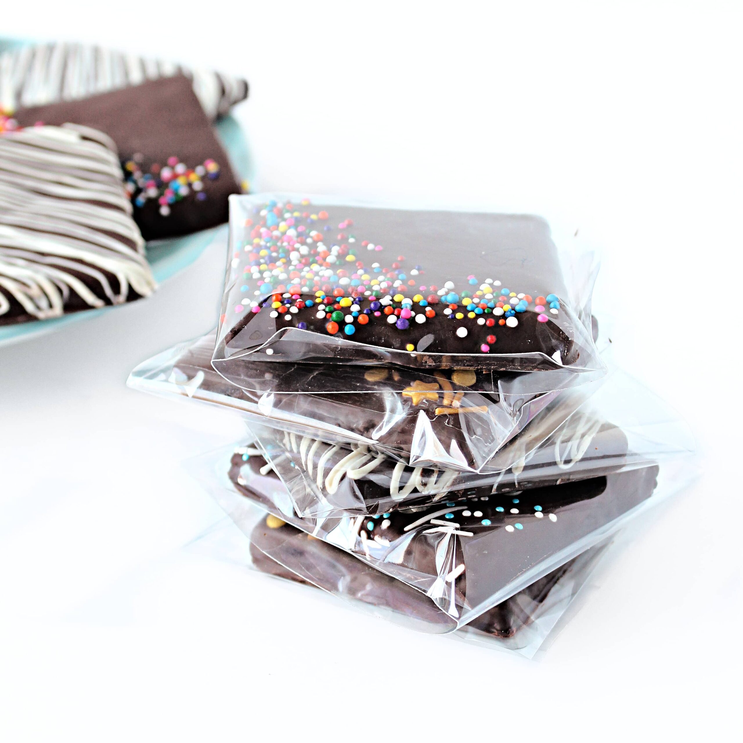 Stack of Chocolate Coated Graham Crackers in individual cellophane bags.