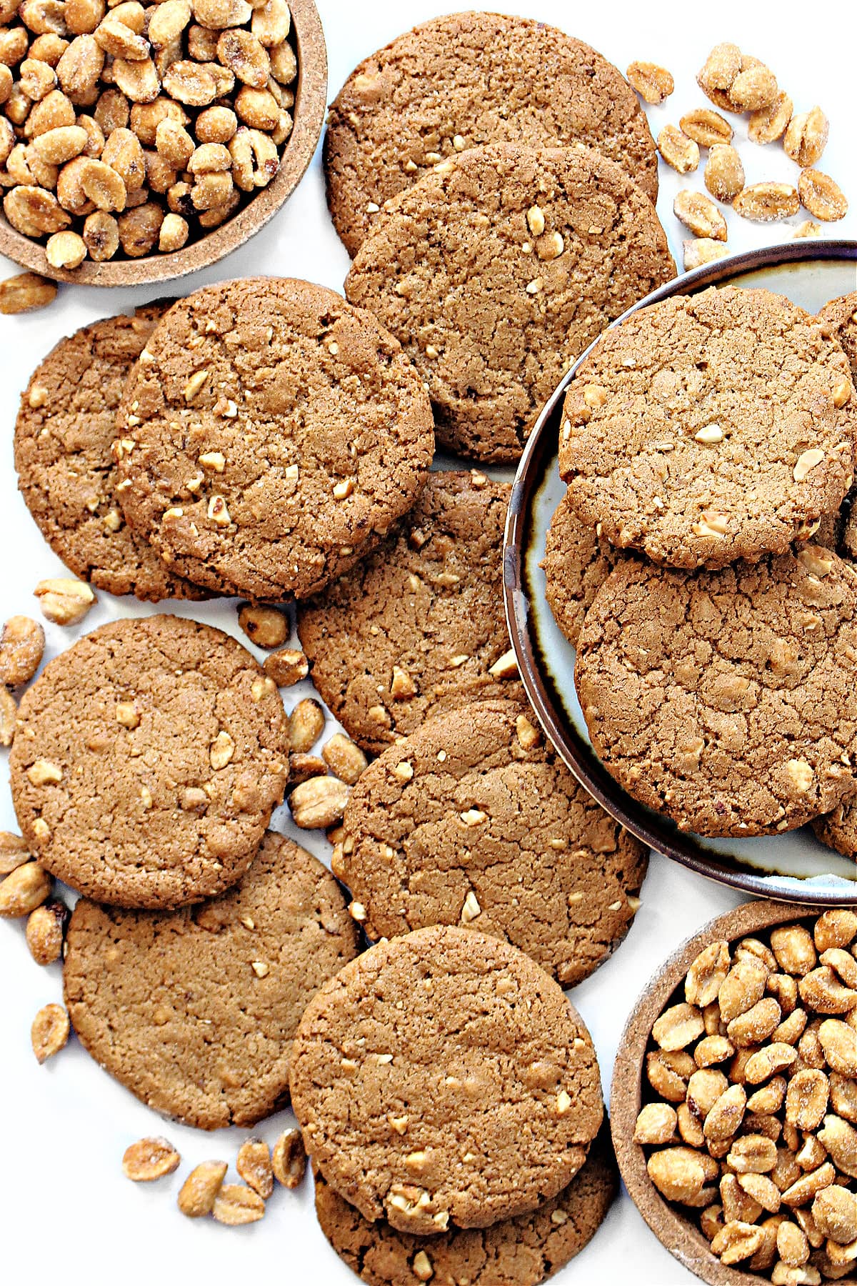 Flat, round Honey Roasted Peanut Cookies with bits of chopped peanuts visable in the dough.