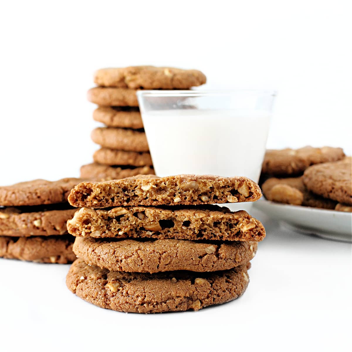 Stacked Honey Roasted Peanut Cookies with one cookie halved to show airy interior texture.