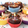 Birthday Cake Cookies topped with chocolate glaze, sprinkles, and lit candle.