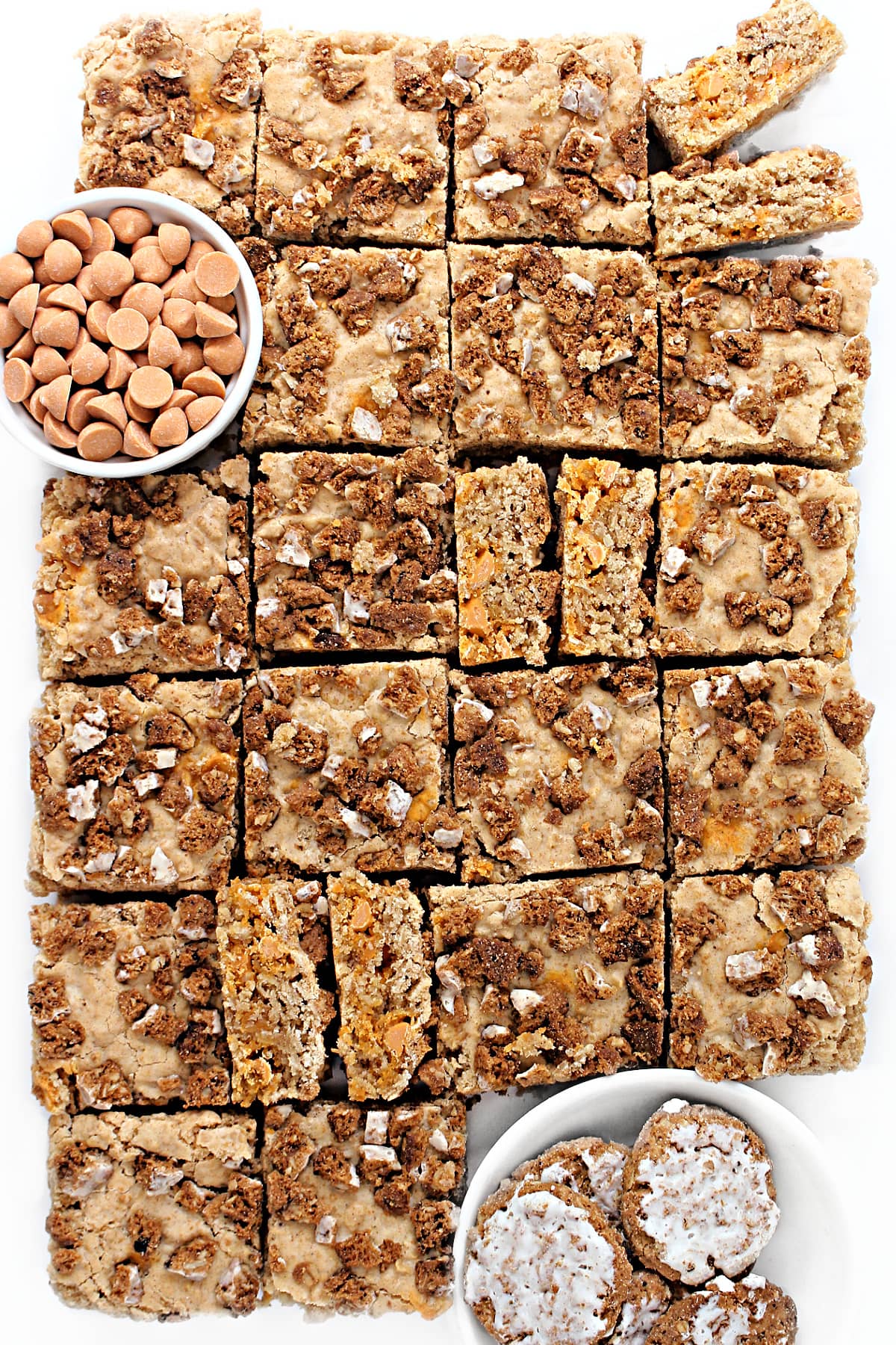 Squares of Butterscotch Oatmeal Bars topped with chopped, crunchy, oatmeal cookie bits.