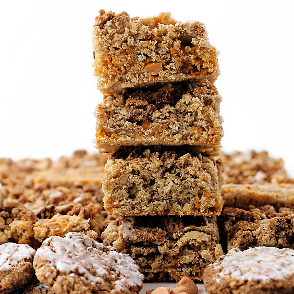 Stack of oatmeal scotchies bars showing chewy, oat filled interior with butterscotch chips.