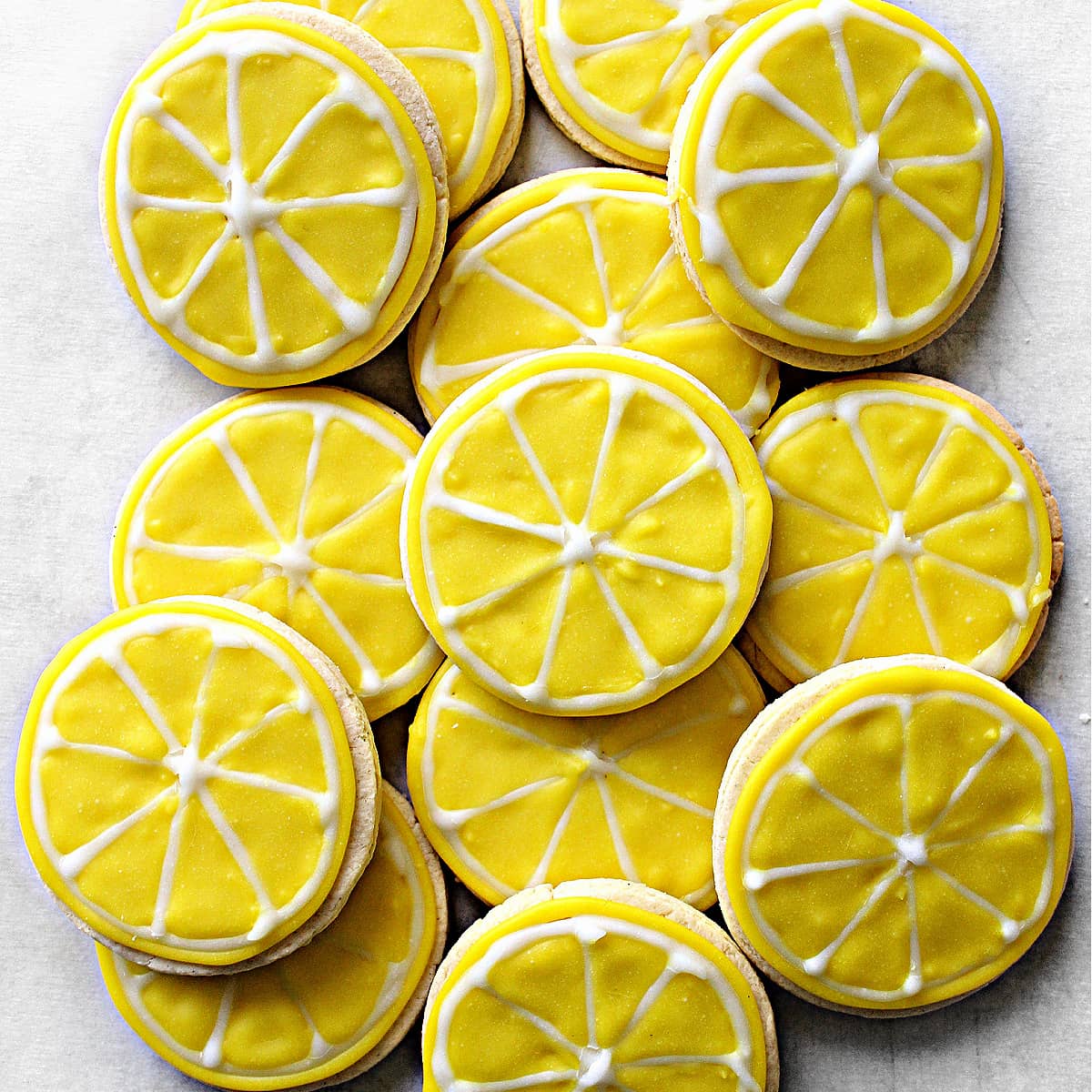 Circle shaped Lemon Sugar Cookies Decorated Like Lemon Slices with yellow and white glaze icing.