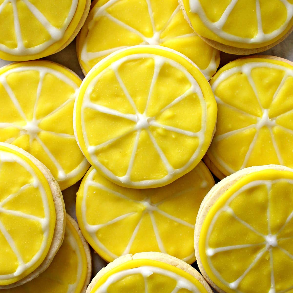 Lemon cut-out cookies decorated with yellow and white icing to look like lemon slices.
