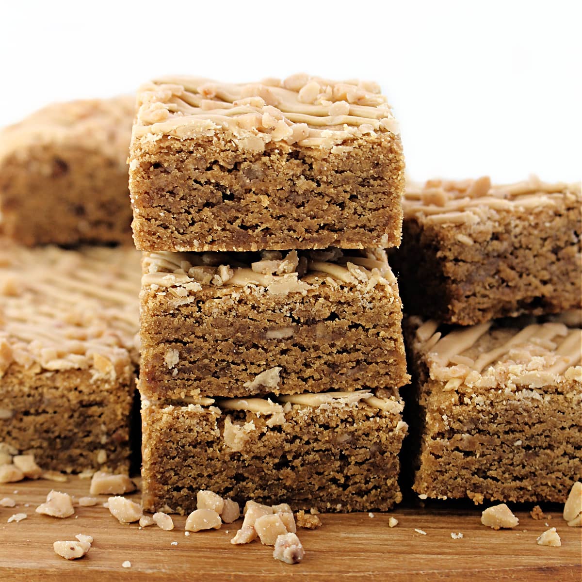 A stack of three cookie butter bars showing the dense, chewy texture dotted with crunchy bits of toffee.