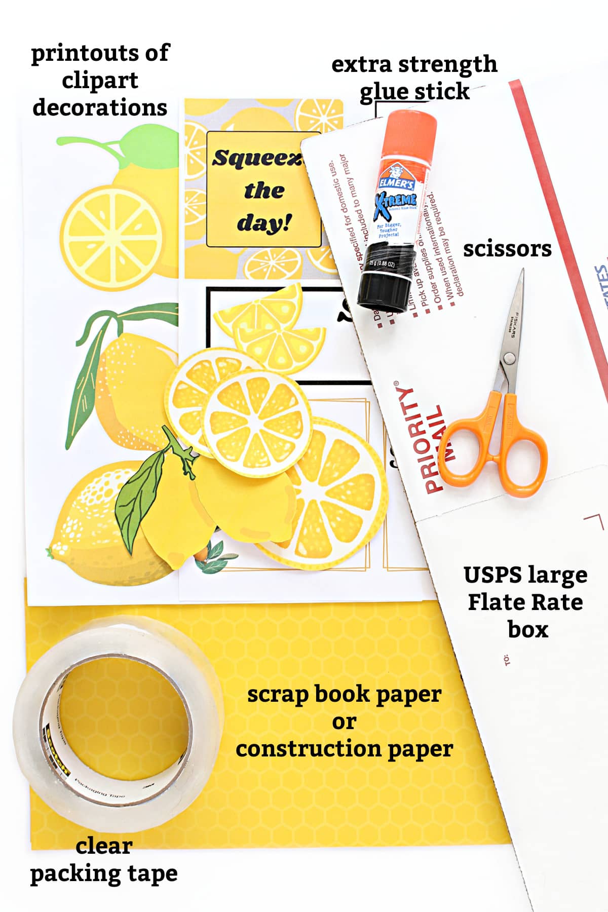 Decorating supplies: printouts of clipart decorations, glue stick, scissors, USPS large flat rate box, scrap book paper, clear packing tape.