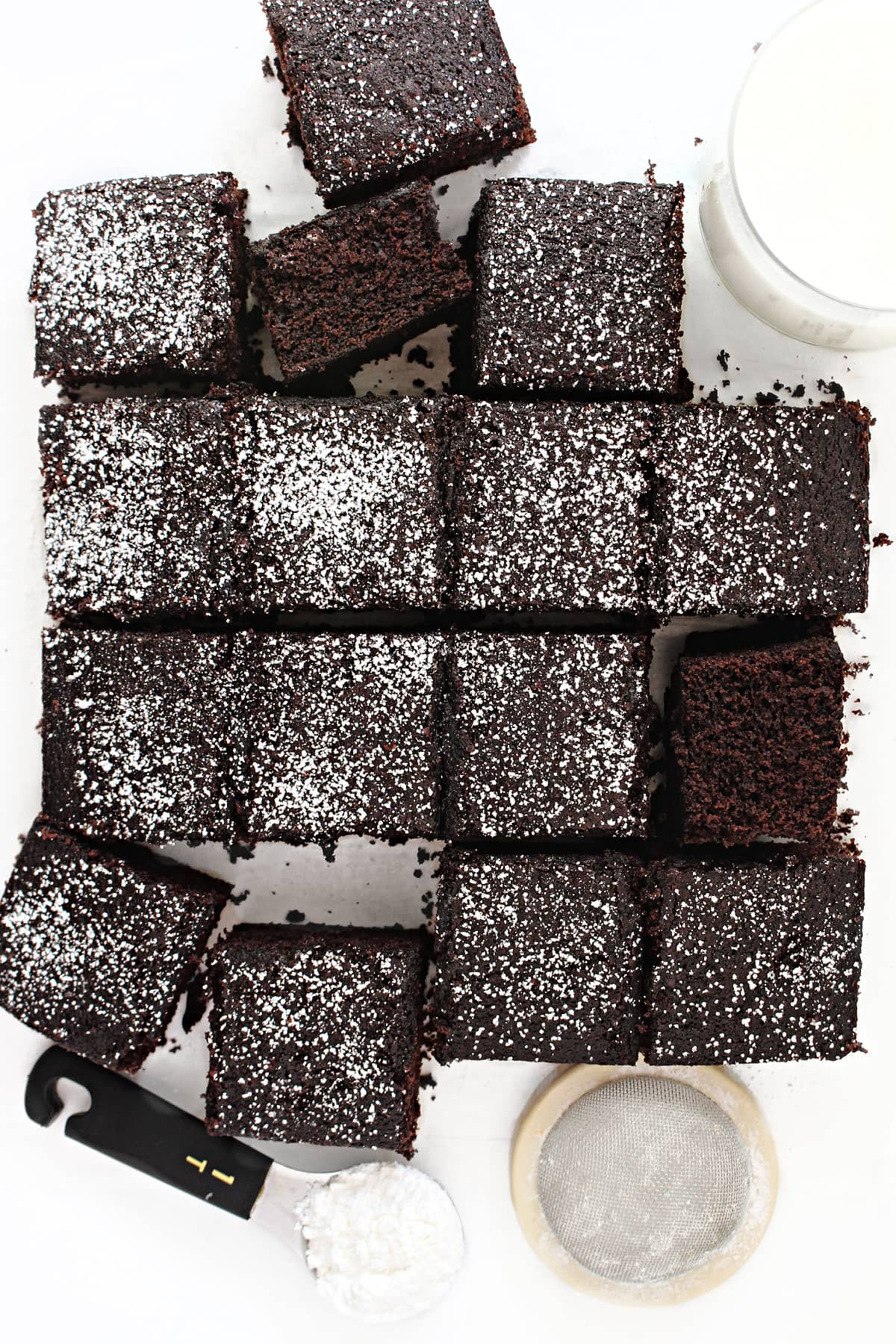 Tender, fluffy Chocolate Snack Cake sprinkled with powdered sugar and cut into squares.