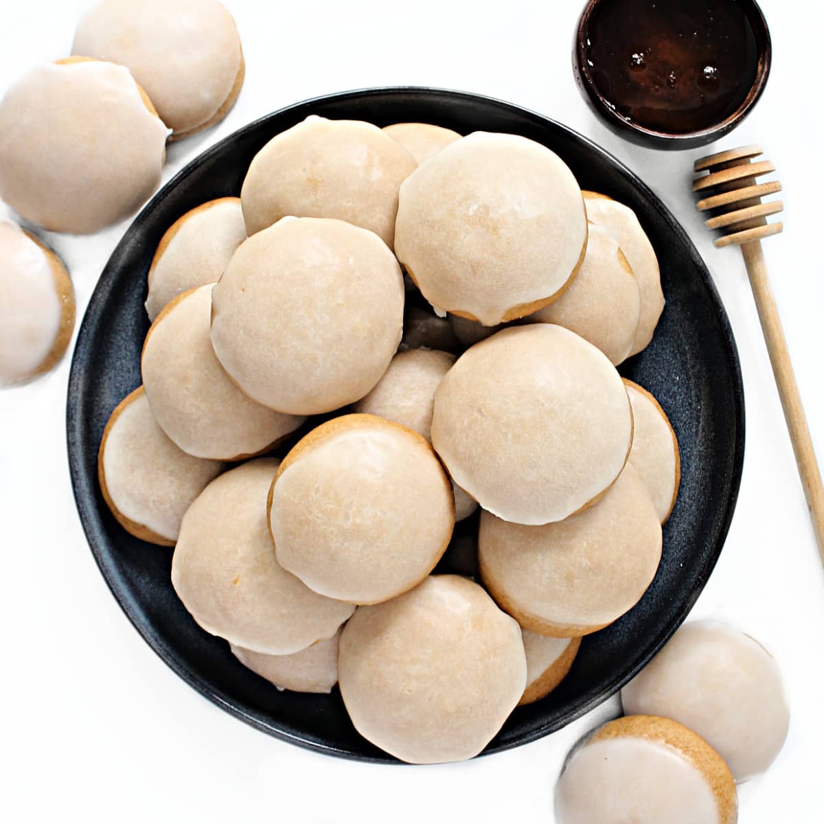 Iced Honey Cookies piled on a serving plate.